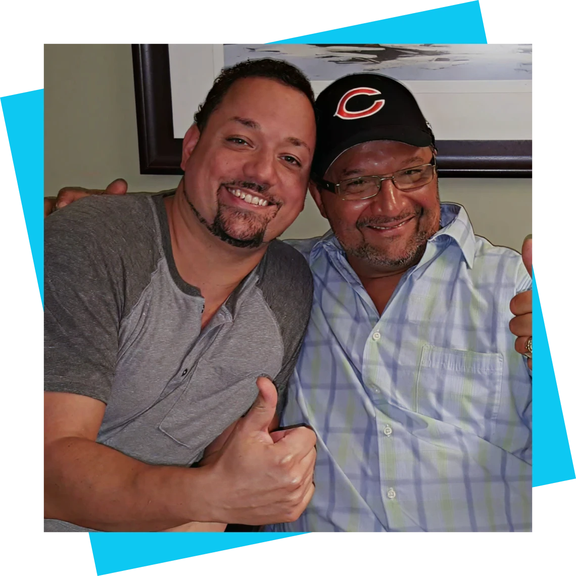 Two men smiling and embracing